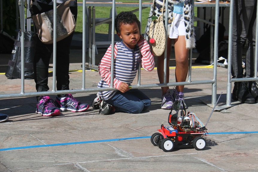 Six-year-old Tedros Tang playing with cars