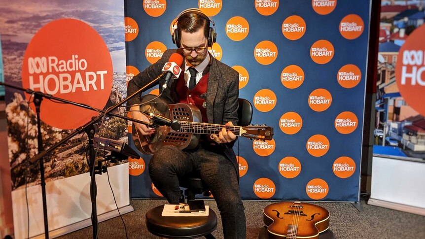 Blues musician Mangus performing on his National guitar in the ABC Radio Hobart studio