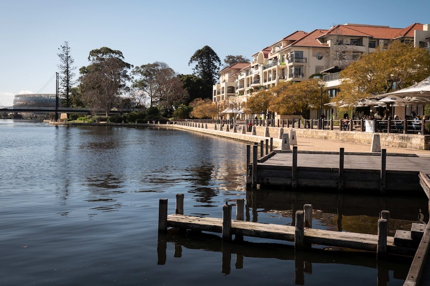 River inlet with limestone embankment, with cafes and apartments.