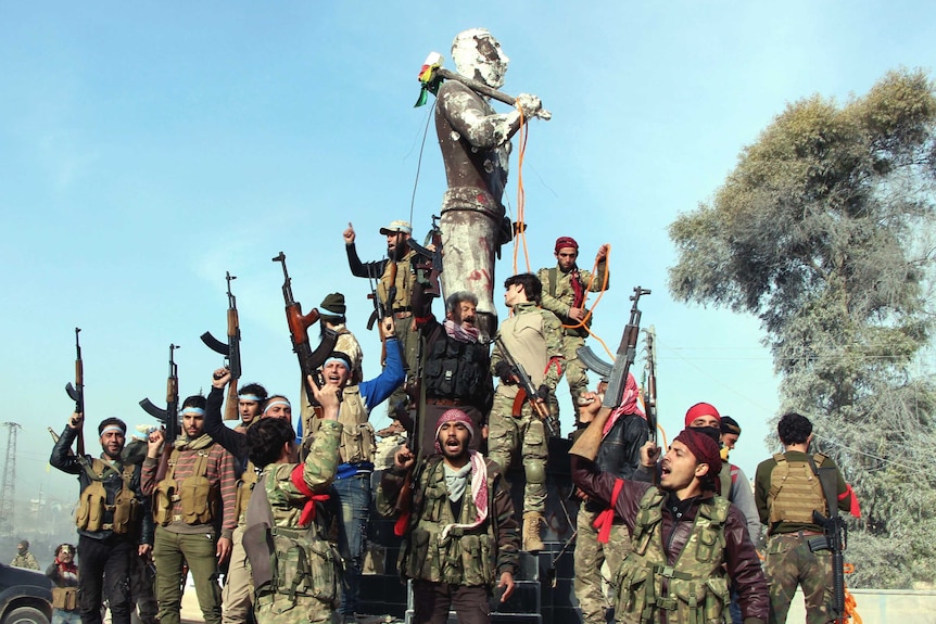 Wide shot of a group of men with guns standing next to a statue.