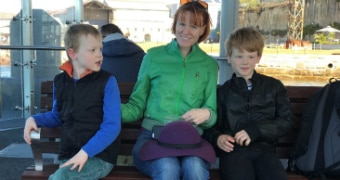 Briana Blackett sits between her two young children