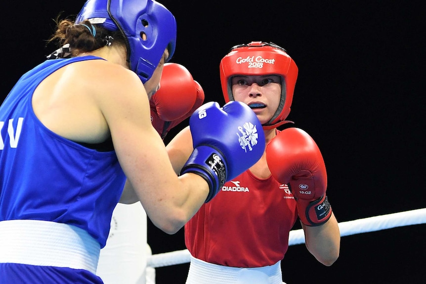 Australia's Skye Nicolson (R) in a women's boxing semi-final against Canada's Sabrina Aubin-Boucher.