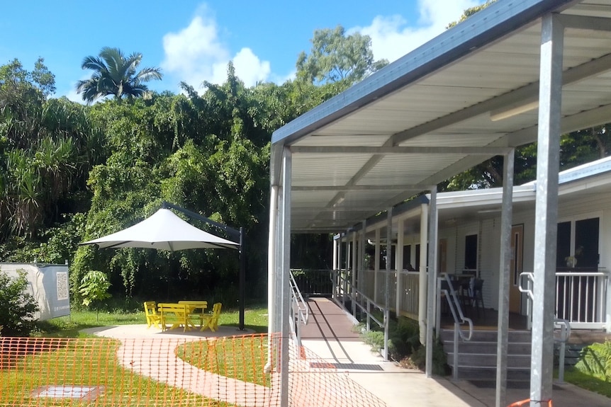 Skyspan umbrella at Cairns School of Distance Education on left, school building with ramps on right