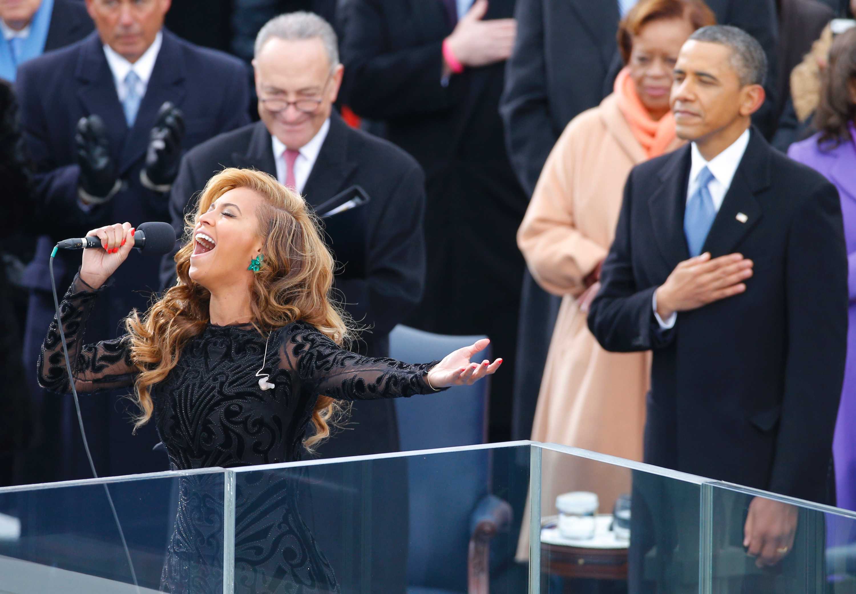 Beyonce sings the US National Anthem as Barack Obama listens.