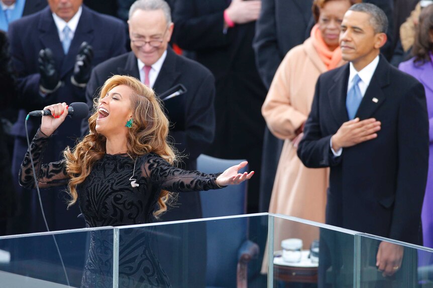 Beyonce sings the US National Anthem as Barack Obama listens.