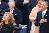 Beyonce sings the US National Anthem as Barack Obama listens.