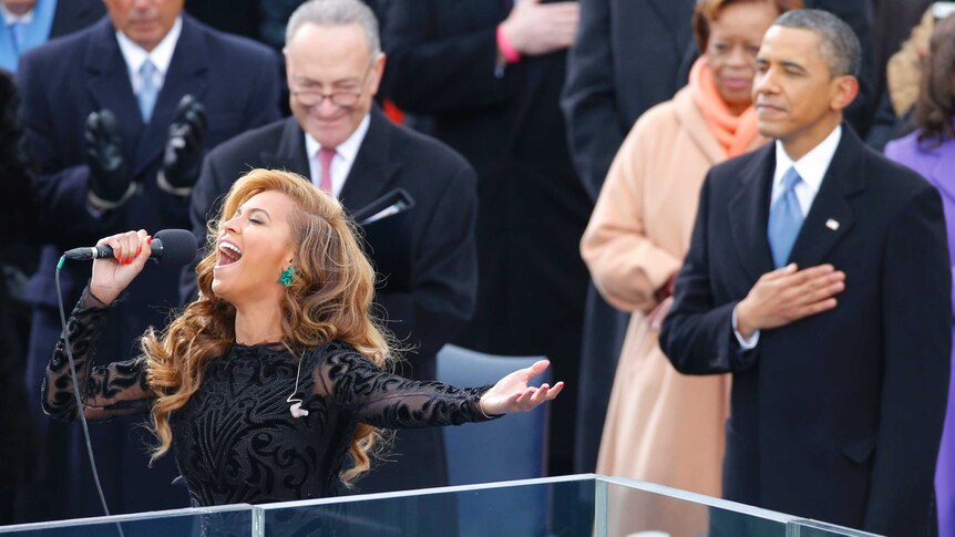 Beyonce sings the US National Anthem as Barack Obama listens.