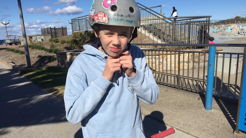 Ethan strapping his helmet on