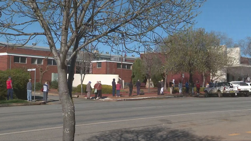 A line of people waiting for COVID testing on the street in Temora 