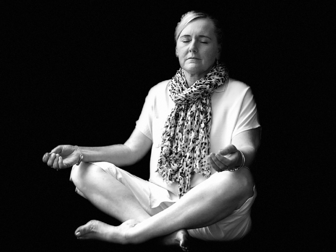 Woman meditating with eyes closed.