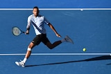 Nick Kyrgios plays a forehand on the run in the Brisbane International