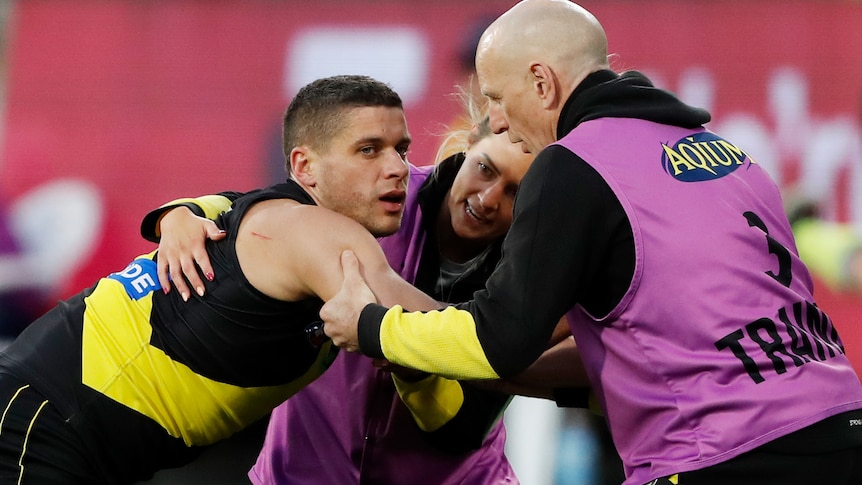 Dion Prestia looks groggy while being attended to by Richmond medical staff