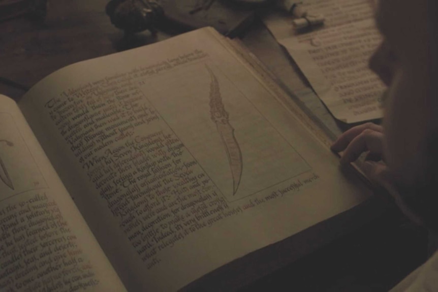 A dagger in a book in a still image from HBO's Game of Thrones