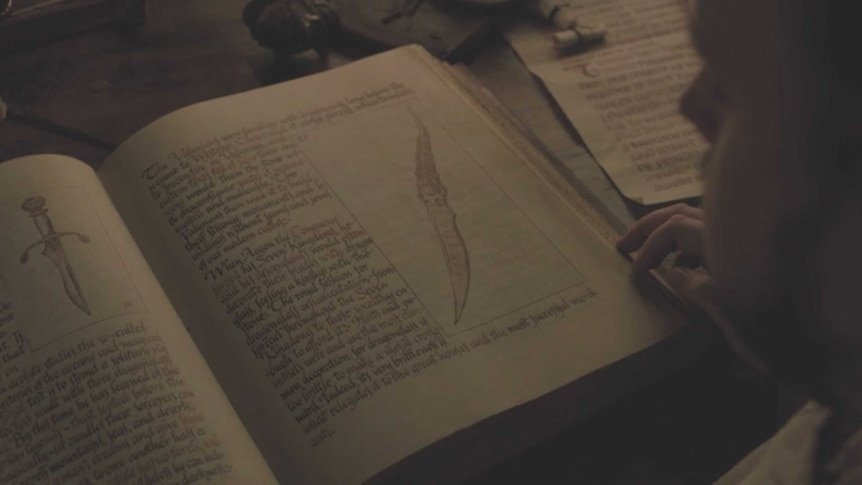 A dagger in a book in a still image from HBO's Game of Thrones