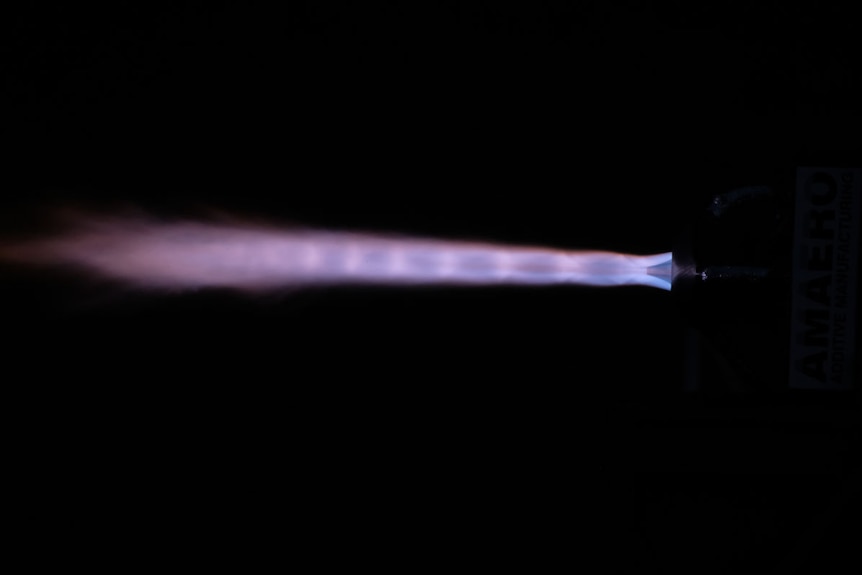 The rocket and its plume flying through the air.