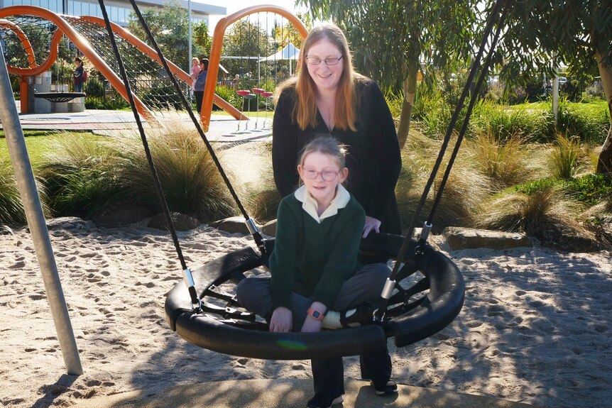Melanie Morris and daughter Kaitlyn Morris in a playground.