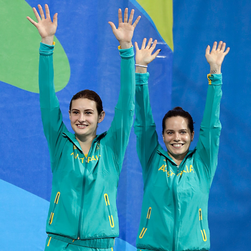 Maddison Keeney and Anabelle Smith with hands up before accepting bronze medal in Rio