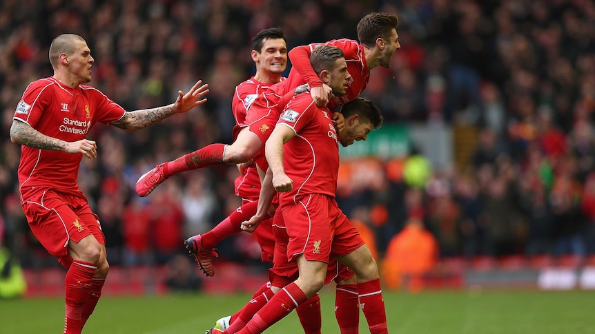 Jordan Henderson (C) of Liverpool celebrates with teammates