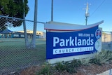 Sign at entry to school that reads "welcome to Parklands Church College".
