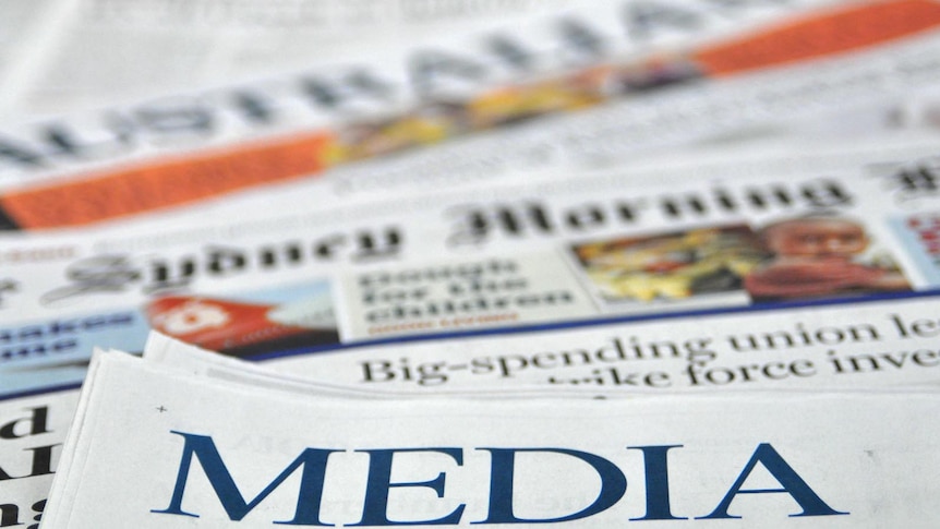 A pile of Australian newspapers with the term "media" in the foreground