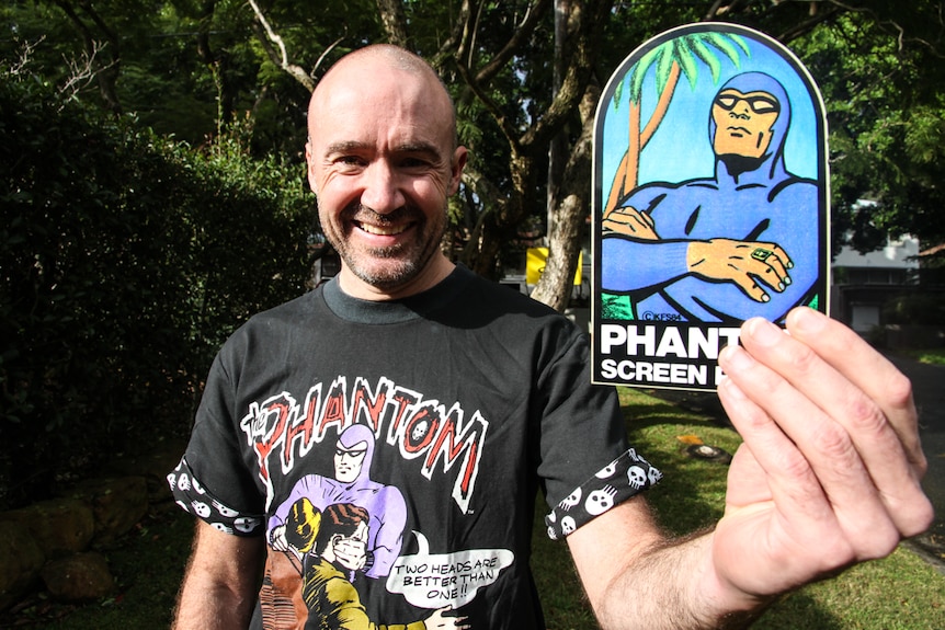 a man holding a phatom sticker