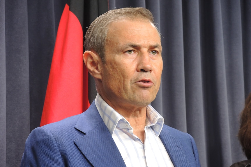 A head and shoulders shot of Roger Cook speaking at a media conference.