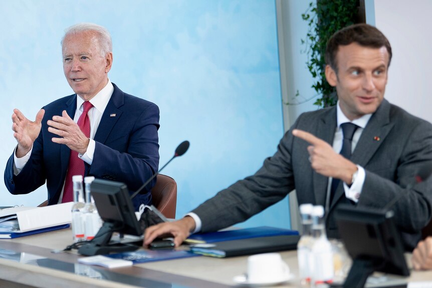 US President Joe Biden listens as France's President Emmanuel Macron speaks