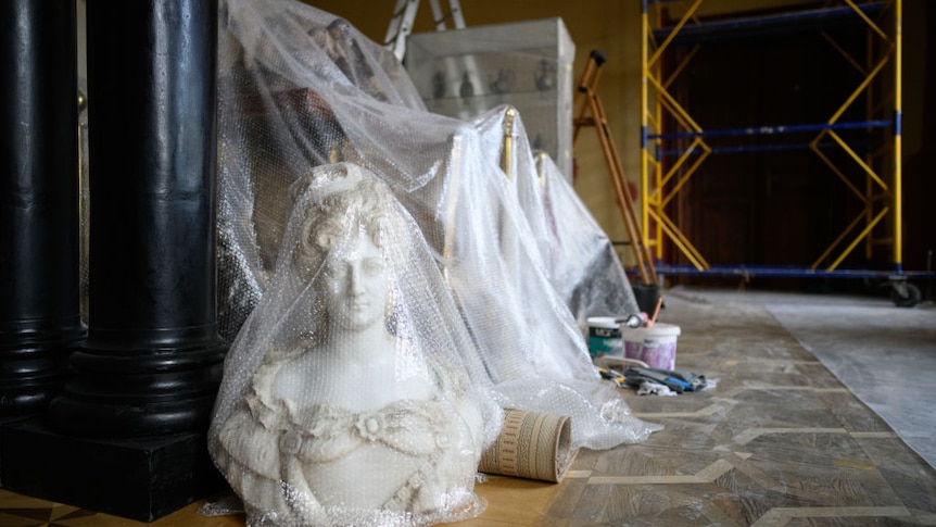 A bubble-wrapped marble bust waits with a small selection of relics to be moved