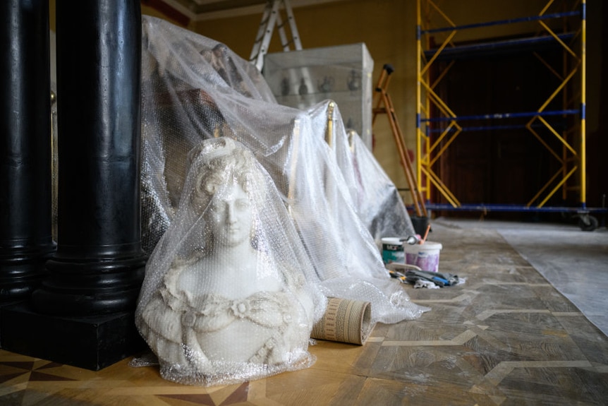 A bubble-wrapped marble bust waits with a small selection of relics to be moved