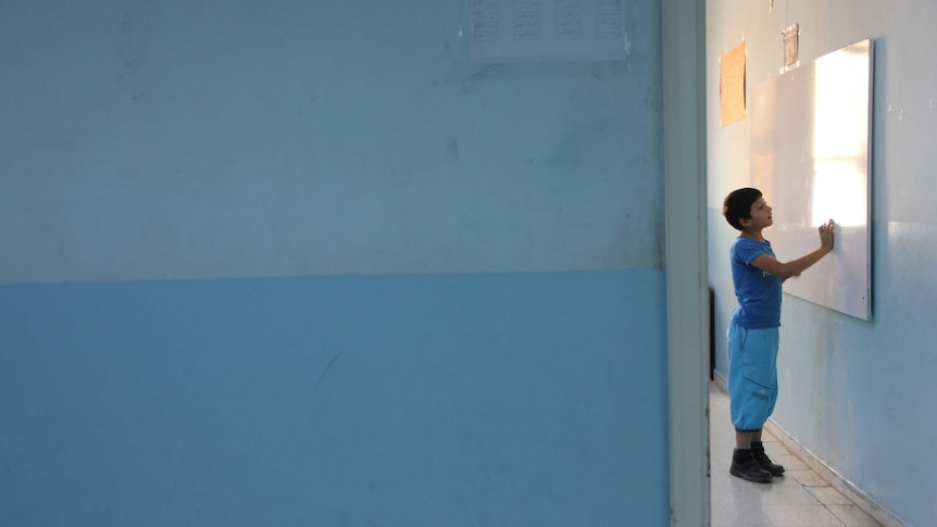 A Syrian refugee student participates in class in Turkey