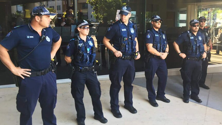 A line of police standing outside Southport magistrates court