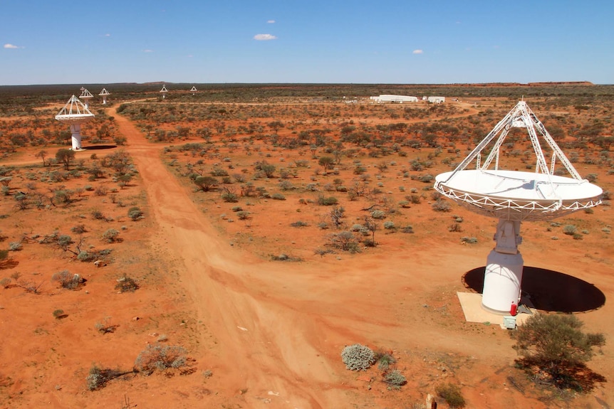 A drone image shows large white antennas built on the red earth of the Murchison.
