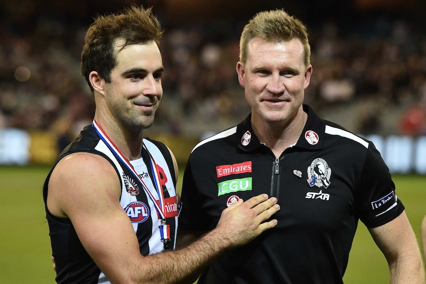 Collingwood's Steele Sidebottom and coach Nathan Buckley (R) after the Magpies' win over Essendon.
