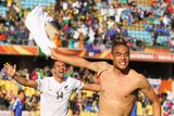 Sting in the tail: Winston Reid leads wild celebrations as New Zealand records a first ever World Cup point.