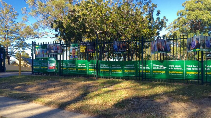 Campaign material for the Nationals MP on a fence outside Toormina High School, in July 2016.