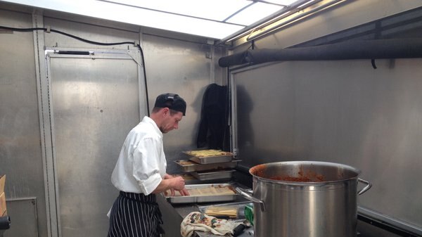 Cook in camp kitchen.