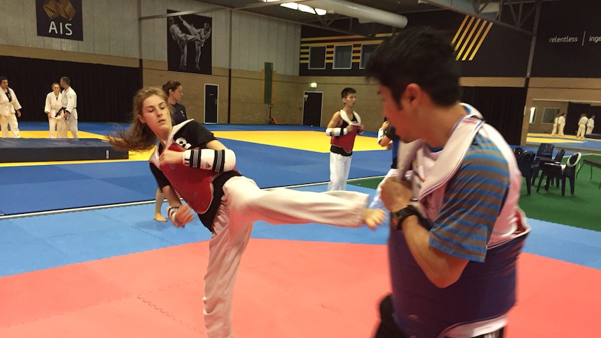 Hopefuls at the AIS combat sport draft selection camp train in taekwondo in Canberra.