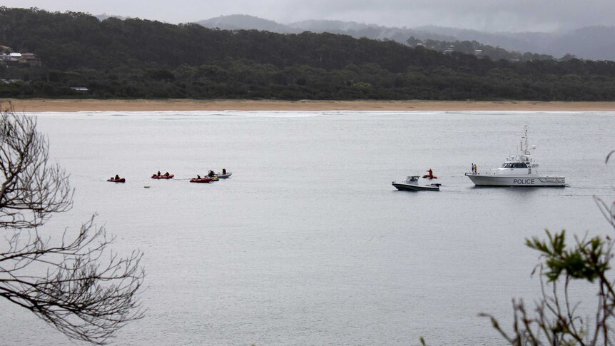 Several boats search the area where Ms Armstrong was taken at Tathra.