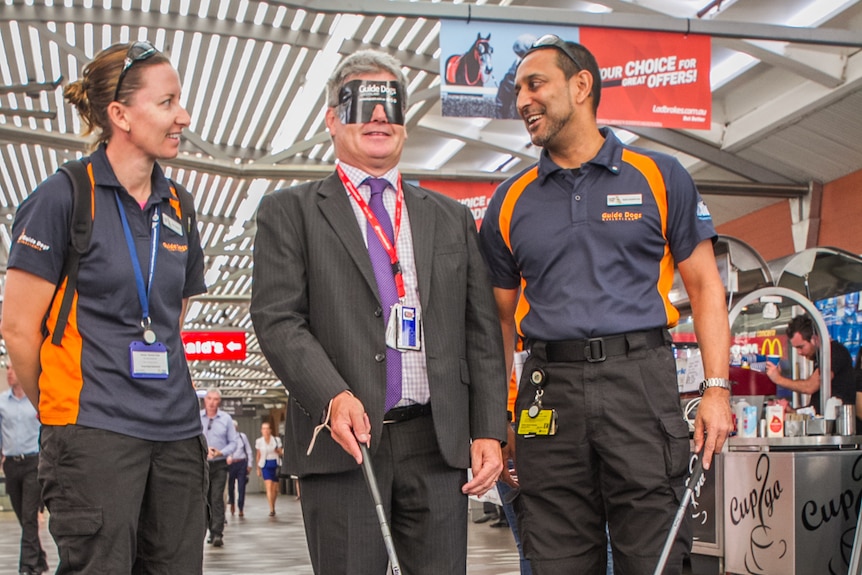 Martin Ryan from Queensland Rail with Guide Dog Queensland instructors Jodie Caldwell and Bashir Embrim.