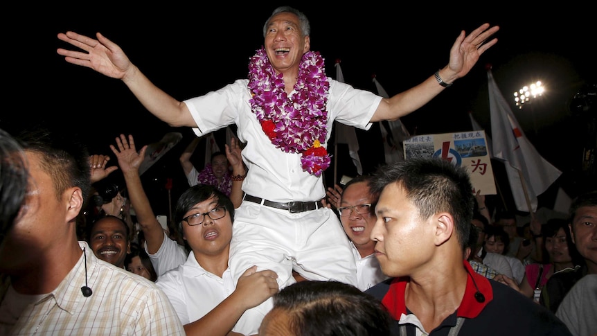 Lee Hsien Loong (C) celebrates with supporters after the general election results