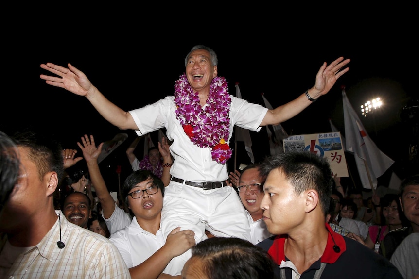 Lee Hsien Loong (C) celebrates with supporters after the general election results