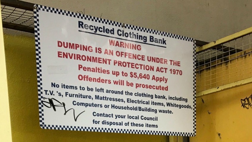 A sign warns against illegal dumping noting "it is an offence under the Environmental Protection Act".