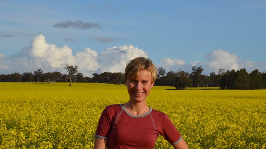 Researcher Dr Marit Kragt stands in a canola field in Western Australia's wheatbelt.