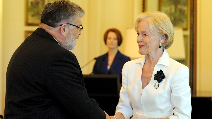 Prime Minister Julia Gillard watches as Governor General Quentin Bryce swears in Senator Kim Carr.