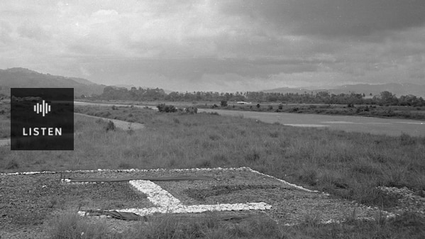 black and white photo of a basic, grassy airstrip. Has Audio.