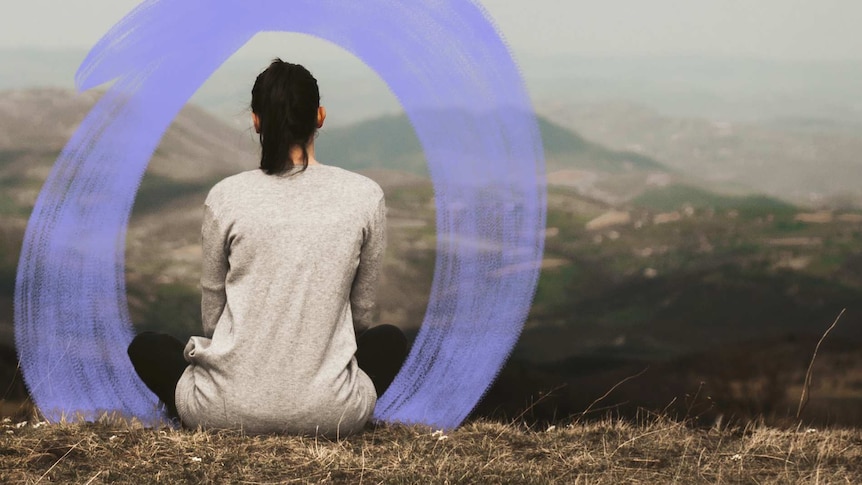 A woman seen from the back sits alone looking at the landscape for a story about a woman's experiences with abortion.