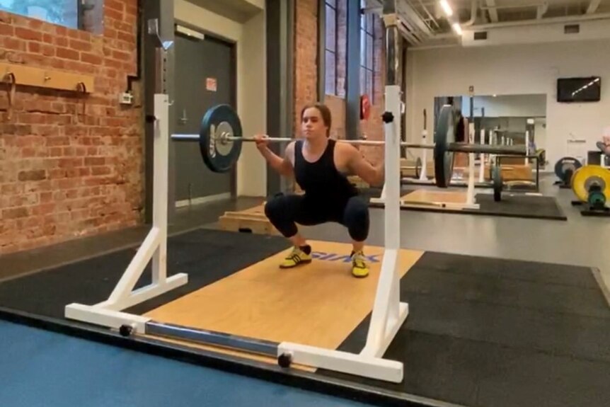 Britt Cox lifts weights.