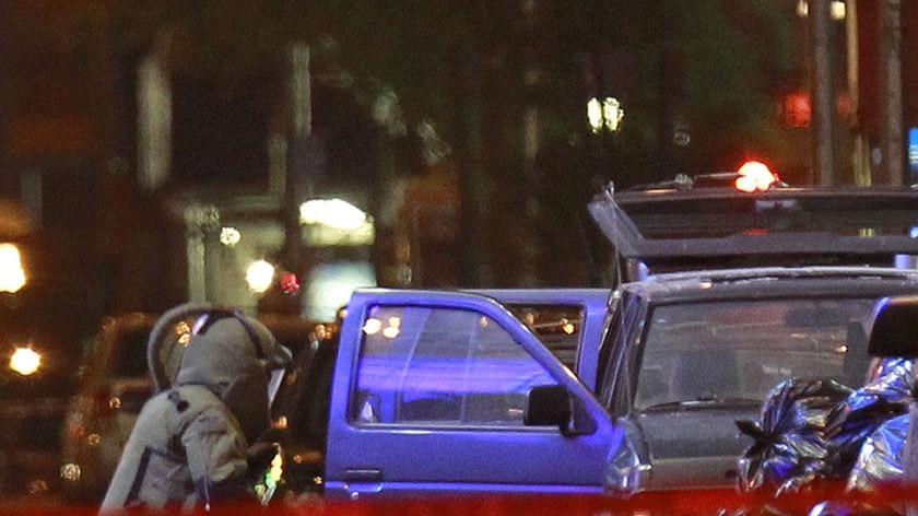 Failed bomb: A NYPD bombsquad officer examines a sport utility vehicle parked in Times Square