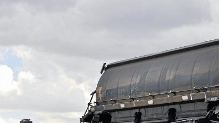 Wagons in precarious position on rail overpass following derailment near Boggabri.