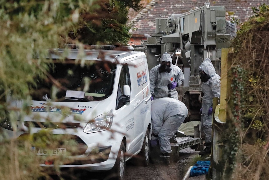 Military forces examine a van in Winterslow